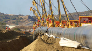 Welded steel pipes are lowered into trenches, Northern Greece, November 2016