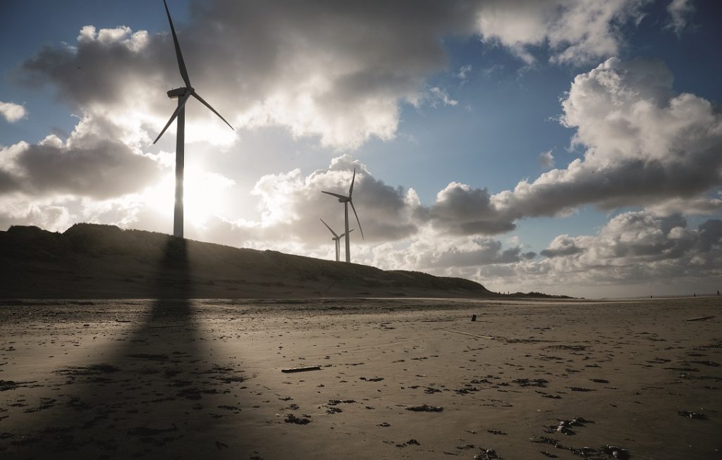 Wind turbines and cloudscape on a beach