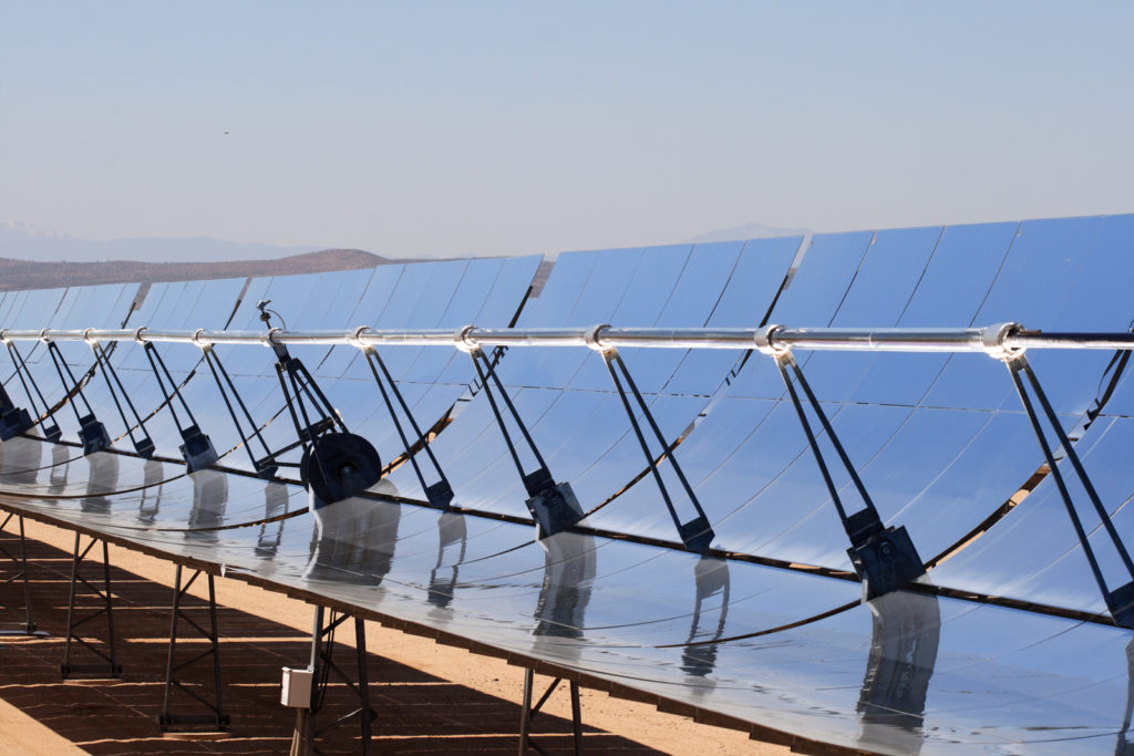 SEGS solar thermal energy electricity plant with parabolic mirrors concentrating the sunlight