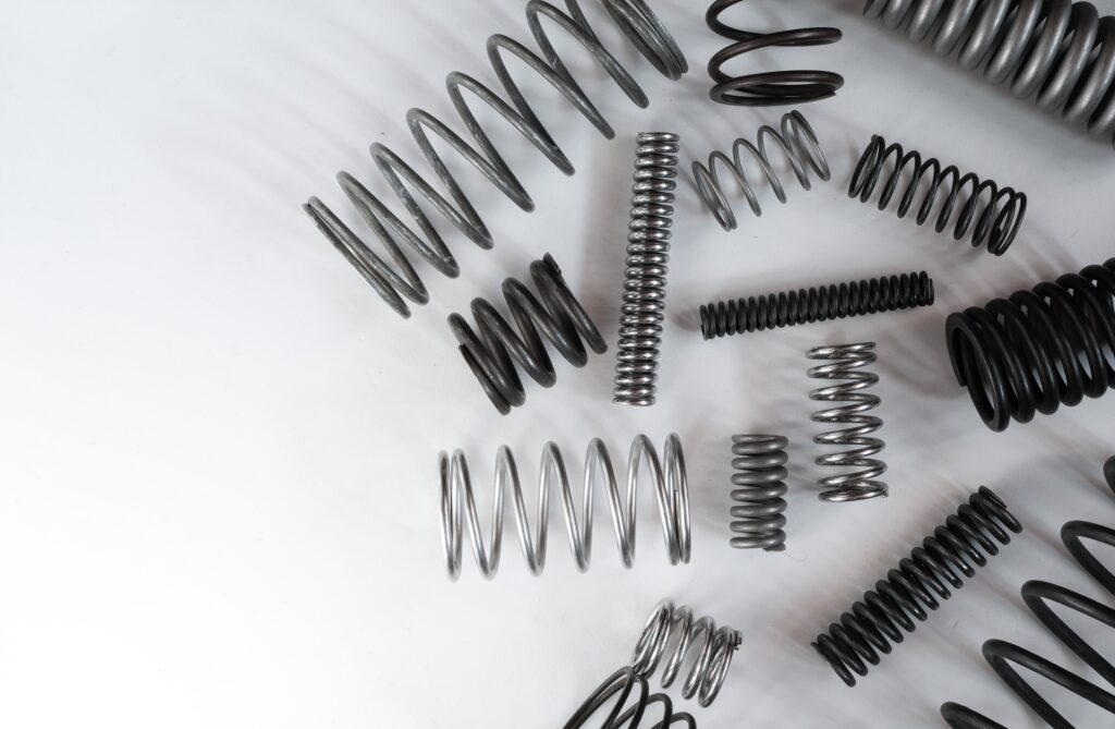 Set,Of,Metal,Coil,Springs,On,A,White,Surface.,Engineering,